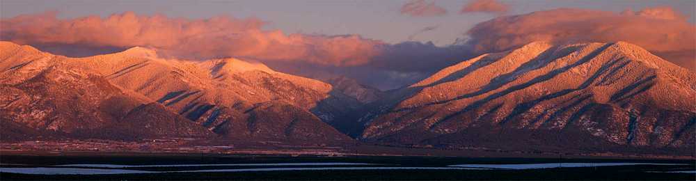 Sunset creates alpen glow on Taos Mountain.
